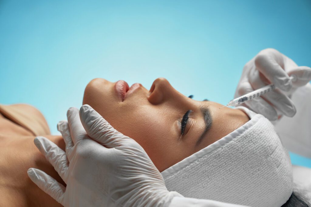Cosmetic Botox Injection In Female Forehead.